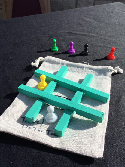 Travel Tic Tac Toe Painted wood with plastic pawns.Travel bag included.